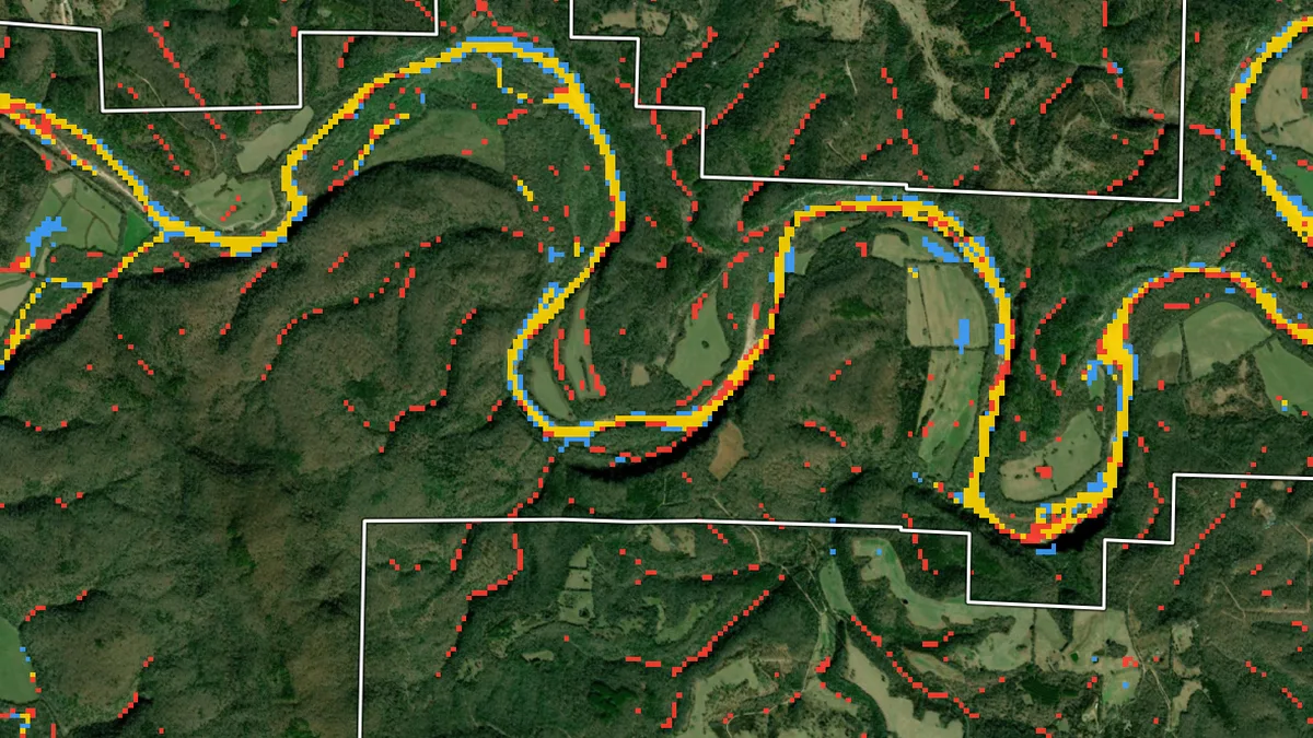 Satellite view of Buffalo River meanders with modelled and OPERA satellite flood extent overlaid in yellow, blue and red
